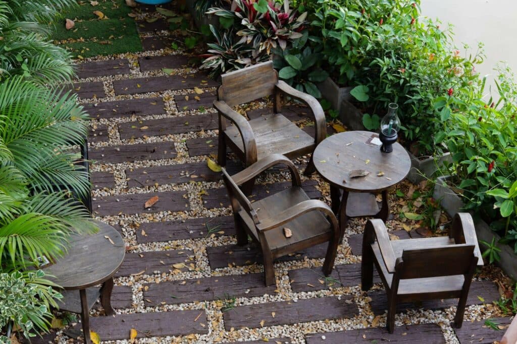 wooden furniture arrayed on a natural stone patio, aerial view