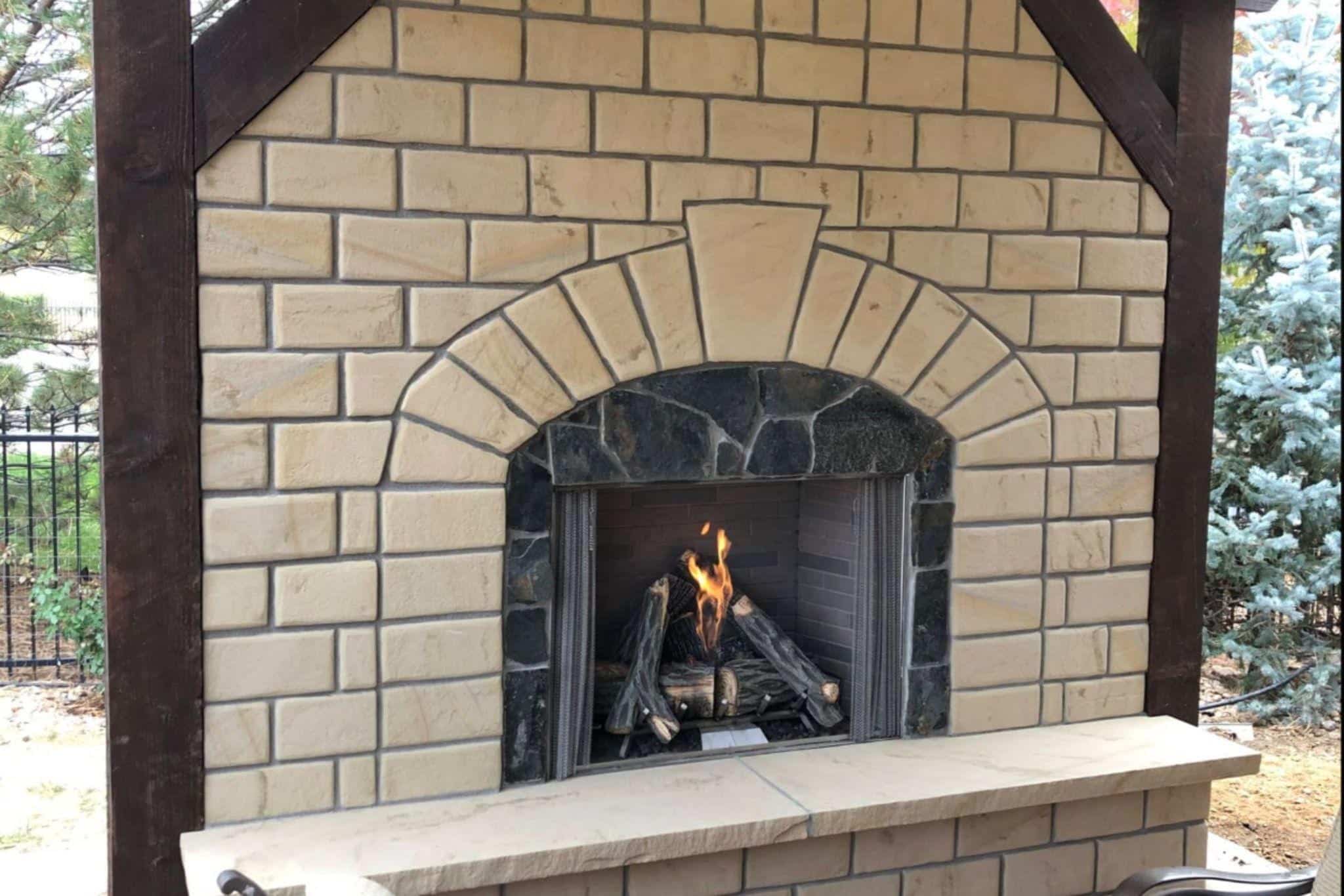 outdoor fireplace with light snow in the background